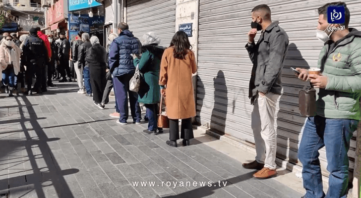 إلتزام عدد من المواطنين بإجراءات الوقاية من كورونا أمام أحد مطاعم وسط البلد