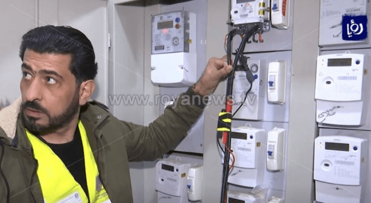 شخص أمام عدادات الكهرباء