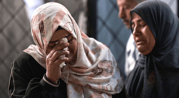 فلسطينيتان تبكيان بعد استشهاد أقارب لهما في قطاع غزة